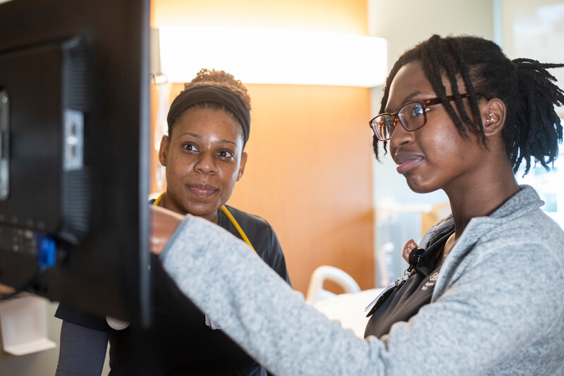 Two nurses at Geisinger review medical records.